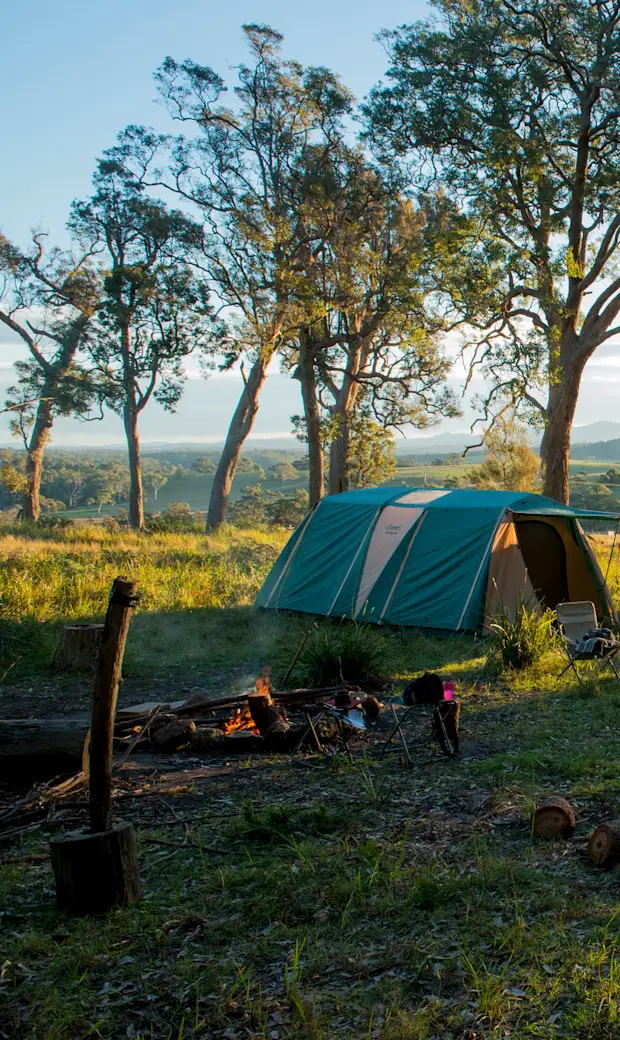 Tent pitched on a private farm campsite listed on Hipcamp with a mountain view at golden hour
